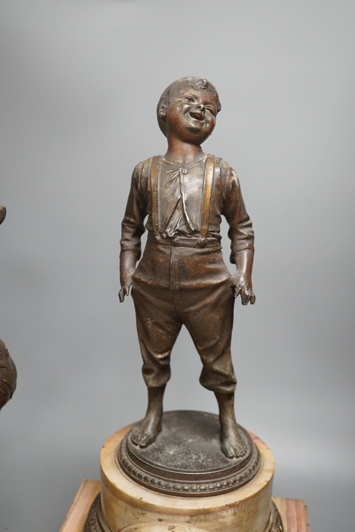 A spelter and marble figural mantel clock and a matching vase 47cm